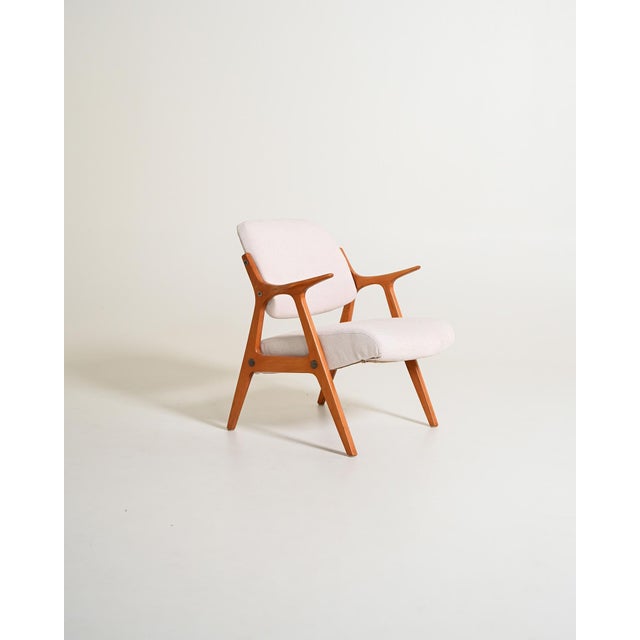 Oak frame and cotton blend upholstery. Scandinavian production, 1960s. Reupholstered. Scandinavian armchair with an oak...