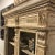 Wood carved vitrine featuring a light distressed finish with carved acanthus leaves and crown moulding, two lower drawers,...