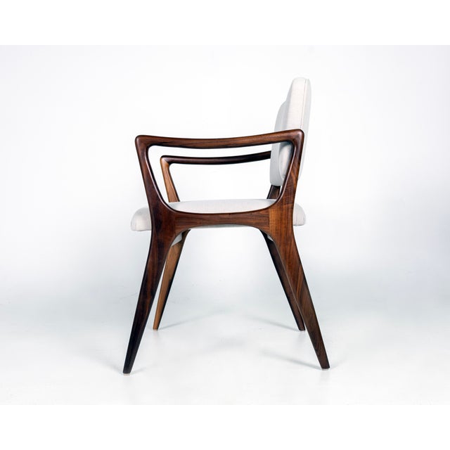 Custom Sculptural Dining Chairs in the style of Gio Ponti. Solid walnut frames, upholstered backs and seats. Arm height is...
