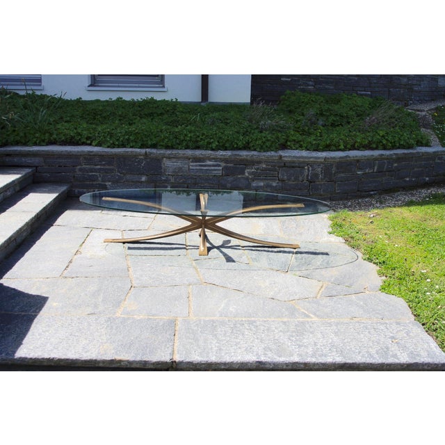 Important and rare oval coffee table by Michel Mangematin, born in 1928, with a star-shaped base composed of 4 ribbed...