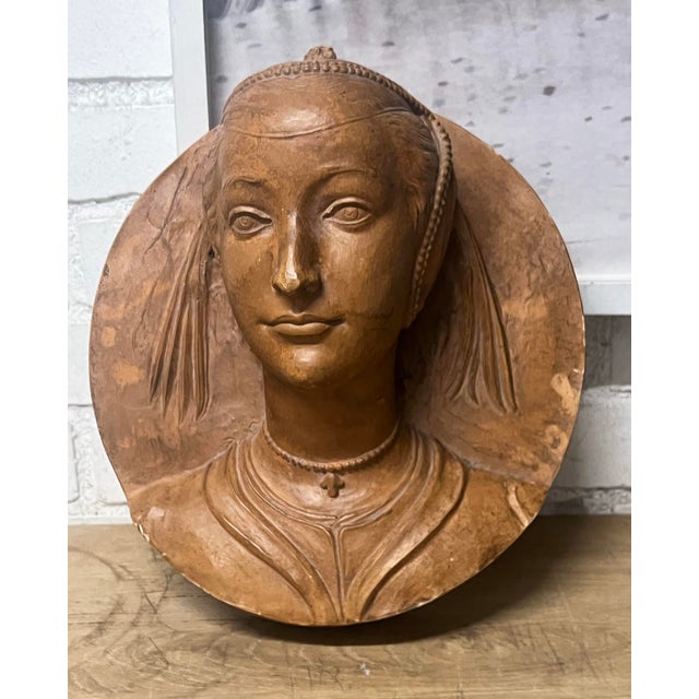 This terracotta medallion portrait depicts a Renaissance-style lady, very similar to a work produced by Frédérich...