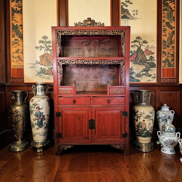 An antique Chinese red lacquer scholar cabinet, dating to the late Qing to early Republic period, executed in a...