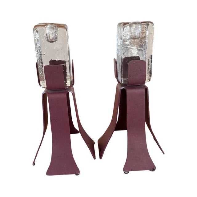 Exceptional pair of Scandinavian Brutalist–Postmodern candleholders, each combining a sculptural hand-forged iron base...