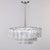 This pair of three tier modernist chandeliers by German maker Doria dates from the 1960s. Chandliers have metal frames...