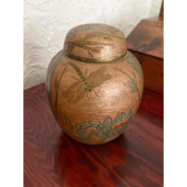 Indian export enameled brass ginger jar with domed lid and an engraved and enameled scene with dragonfly, tall reeds and...