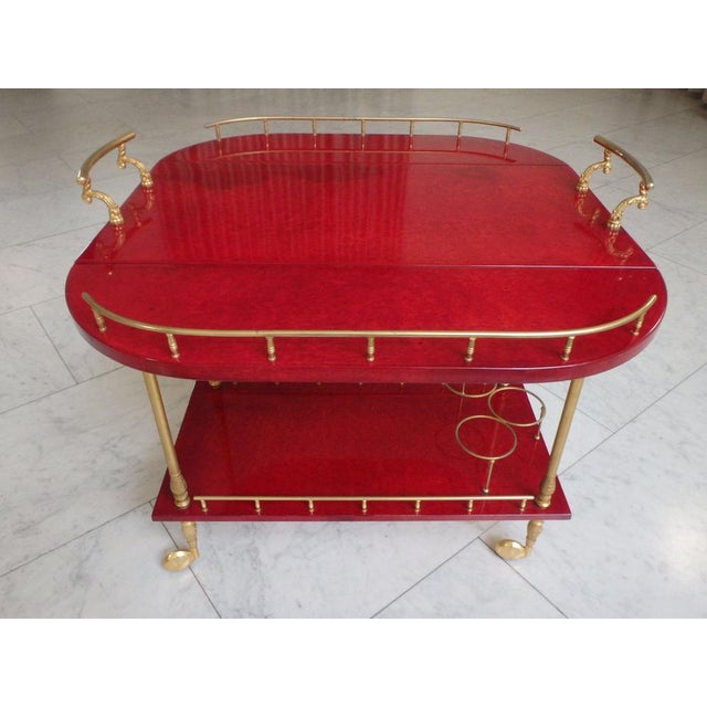 Bright Red Goatskin Bar Cart with Wings by Aldo Tura, in Very Good conditions. Designed 1950 to 1959 This piece has an...