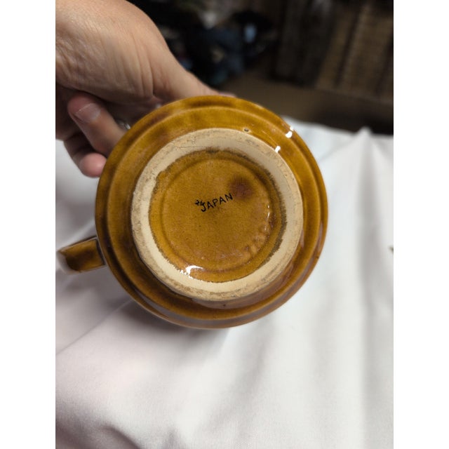 Vintage ceramic soup mug with a handle and bold lettering design. • Features 'Soup' and 'Crackers' text design • Warm...