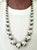 A substantial vintage Taxco sterling silver necklace composed of graduated hand-fabricated beads, tapering from smaller...