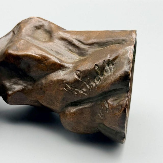 An Art Deco bronze sculpture depicting a resting owl perched on a naturalistic rocky base. Signed and dated 1921 to base....
