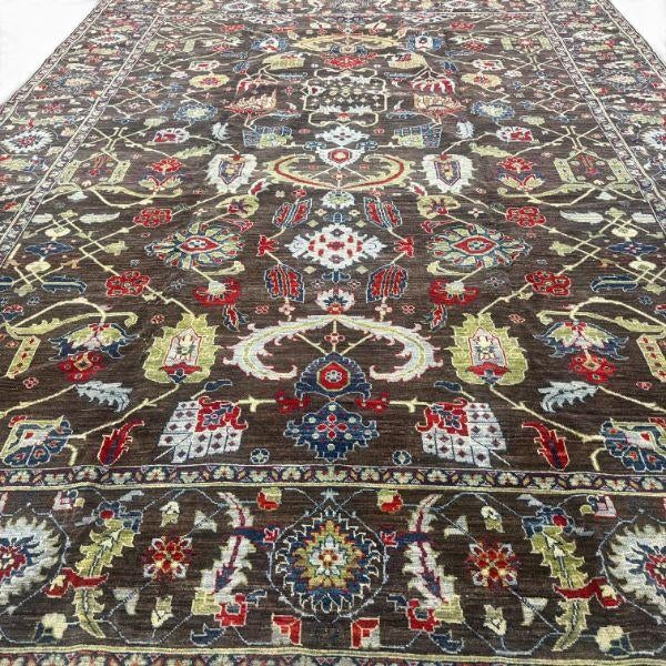 This handmade Afghan rug makes a strong statement with its exceptional allover floral design and richly layered color...