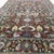 This handmade Afghan rug makes a strong statement with its exceptional allover floral design and richly layered color...