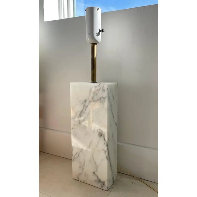 Monolithic statuary marble table lamp, rendered in a solid slab of polished statuary marble with Brass and powder coated...