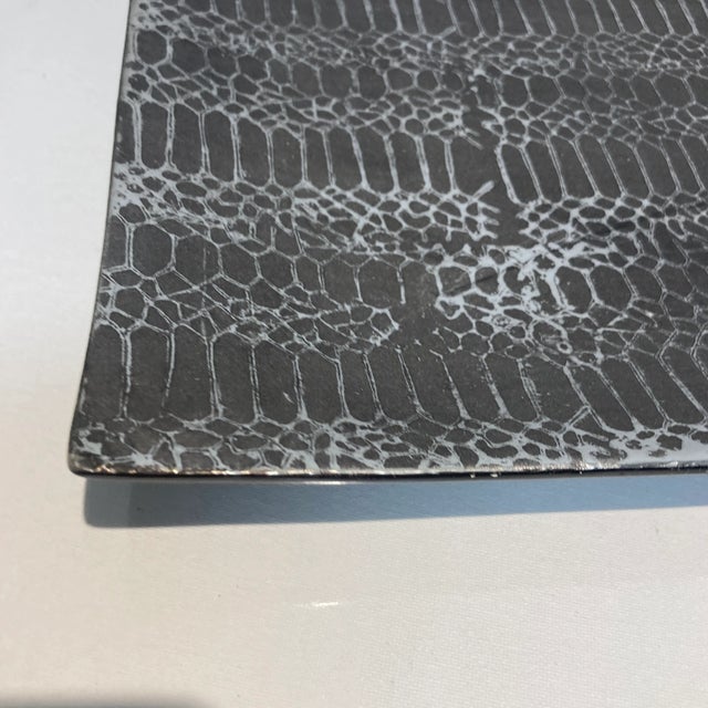 Metallic gray finish embossed and a silver ceramic tray.