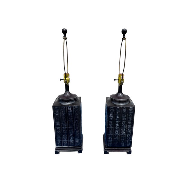 A handsome pair of vintage Chinese-inspired cast metal table lamps featuring an elegant architectural silhouette and...
