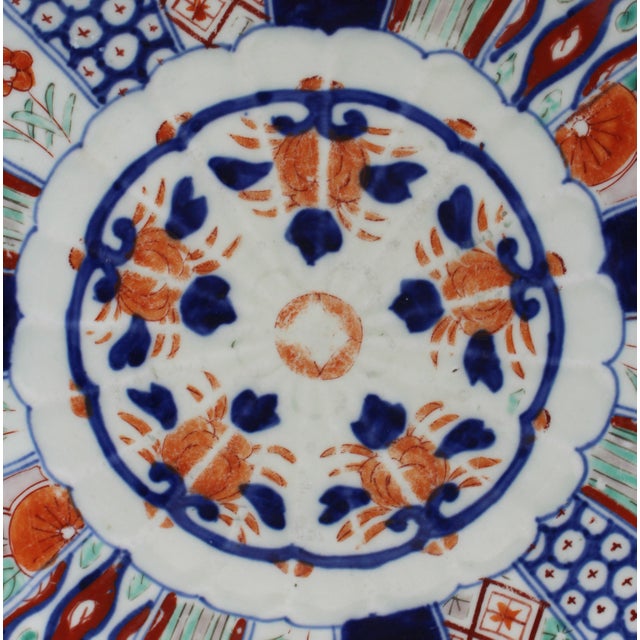 Imari chop plate, circa 1880, Japanese. Lobed form with conforming decorative boarders and "fan" panels of seven different...