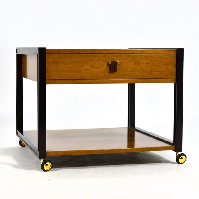 A beautifully detailed table with great proportions, this Ed Wormley end table by Dunbar features a walnut case and shelf...