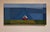 "Overlook" is an acrylic on canvas landscape painting by Justin Wheatley, completed in 2026. A small red house with a...