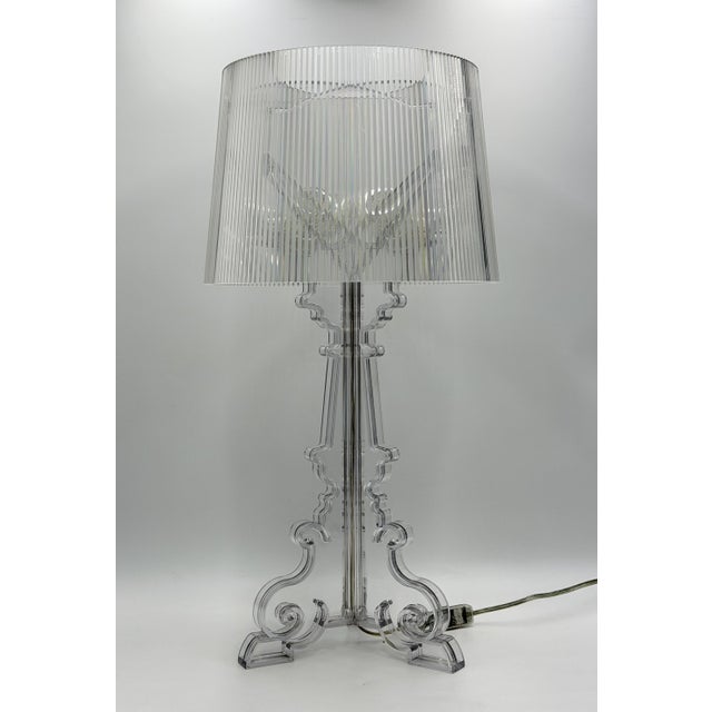 An iconic Bourgie table lamp designed by Ferruccio Laviani for Kartell, Italy, executed entirely in transparent crystal-...