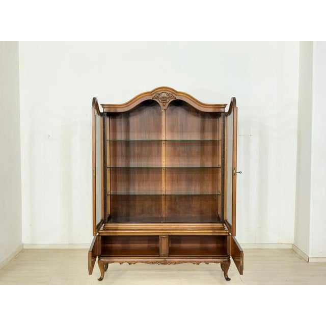 For sale is a magnificent and masterfully crafted display cabinet in the elegant Baroque style, a true highlight in any...