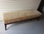 Custom-made upholstered bench with tapered walnut legs and a woven geometric fabric in gold, cream, and black. Clean-lined...