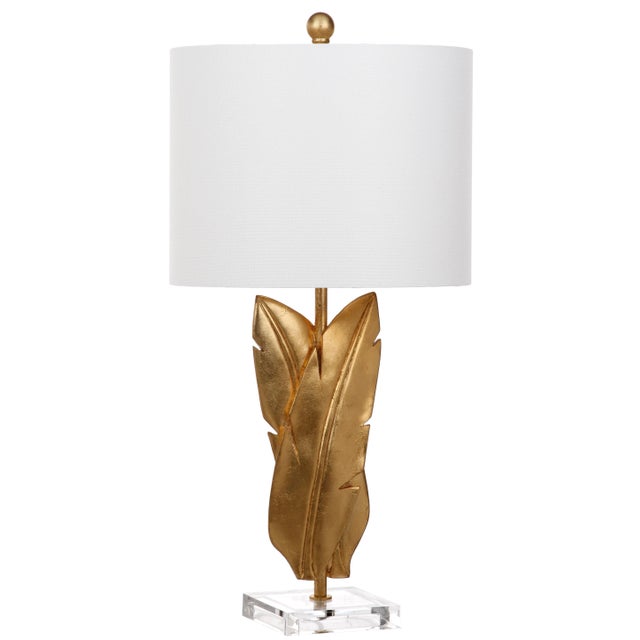 Adorned in a opulent gold finish and paired with a off- white shade, this traditional table lamp - a Pair recalls modern...