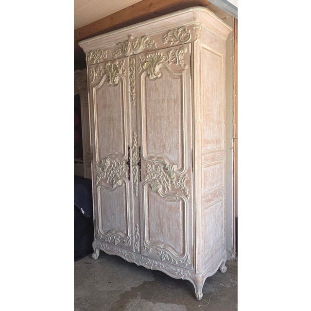 Pretty white non antique highly functional armoire pull out platform that swivels for a small TV or microwave.