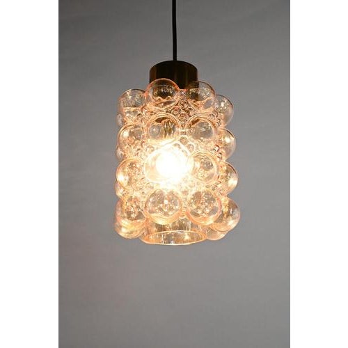 Helena Tynell pendant made of tinted glass with brass. This iconic design classic is designed for the well-known German...