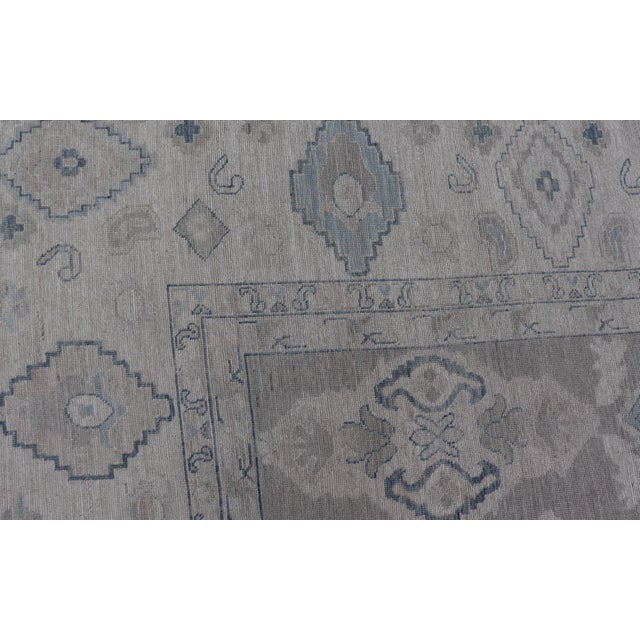 Turkish Oushak Rug With Soft Gray Field and Pale Blue Geometric Motifs For Sale - Image 9 of 16