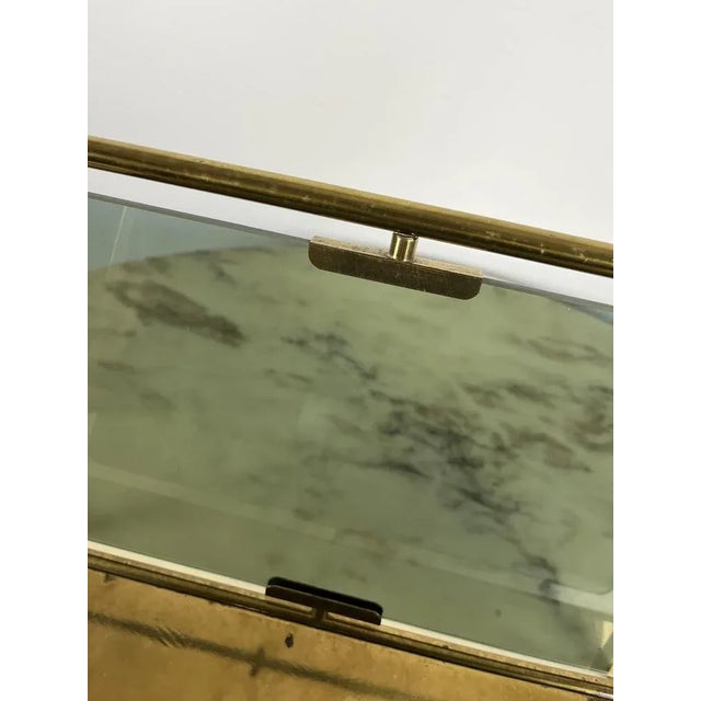 Ottone and glass door, French production of the early 60s. Intact, it presents normal signs of time and use.