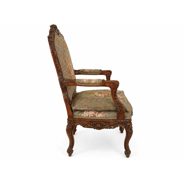 Absolutely gorgeous, heavily carved Walnut armchair wonderfully decorative French Louis XV–style armchair featuring an...