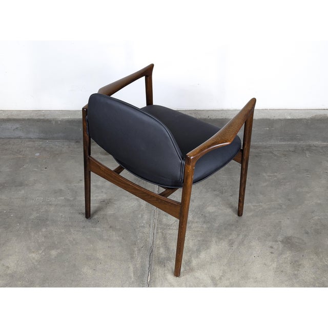 Step into the elegance of the 1960s with this exquisite vintage mid-century modern armchair designed by the renowned Ib...