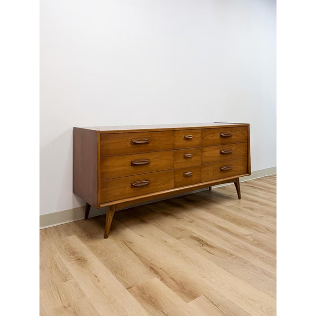 This vintage nine-drawer lowboy dresser by United is a classic example of mid-century modern casegood design, prized by...