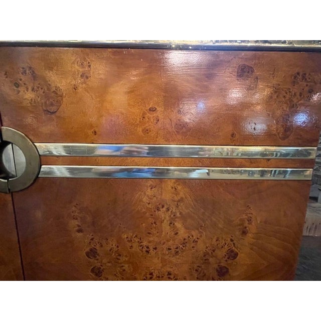 This Italian Burl Walnut and Brass Credenza is a luxurious and stylish piece of furniture inspired by the iconic designer...