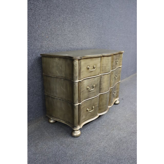 Ethan Allen three-drawer chest crafted from cherry wood, featuring a serpentine front, shaped top with decorative molding,...