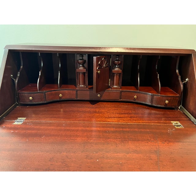 Early 1900s Maddox Mahogany Secretary Desk. Chippendale style. Four external serpentine drawers. Five internal drawers...