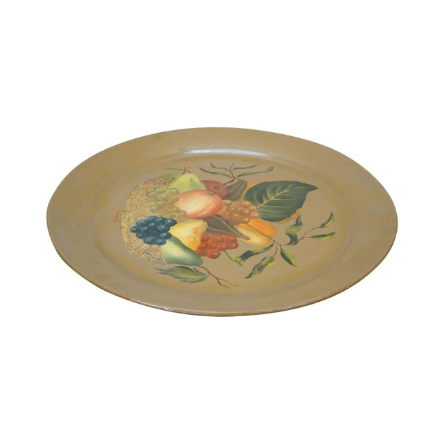 Vintage 20th century toleware metal serving tray / charger plate, hand painted with a basket of fruit on a light brown...