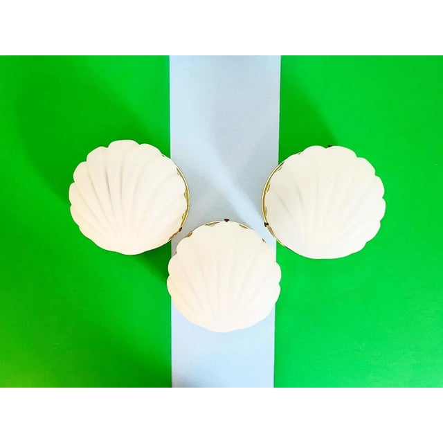 Chic trio of frosted matte glass wall lights/sconces in the style of Limburg with incised scallop shell shades set into...