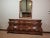 Elegant Henredon dresser with matching framed mirror featuring rich figured wood veneers, serpentine front case, carved...