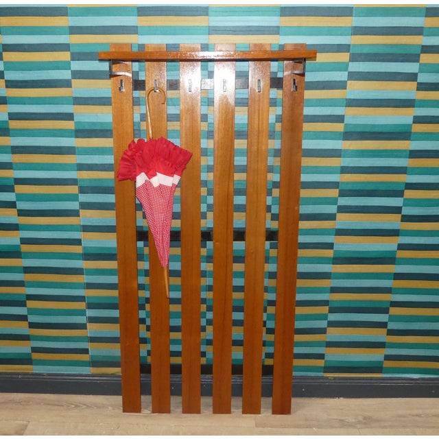 Decorative Highlight 1960s Coat Rack in a stunningly simple design! The combination of teak and black metal is an...