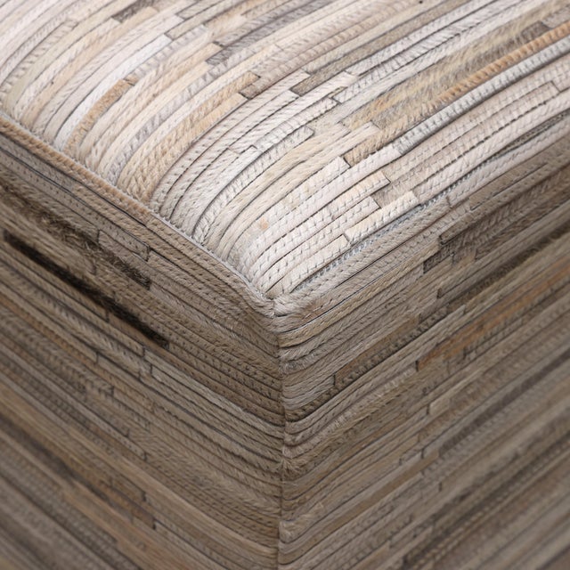"Subtle, layered, and incredibly refined, this handmade cowhide leather pouf is all about texture and quiet luxury....