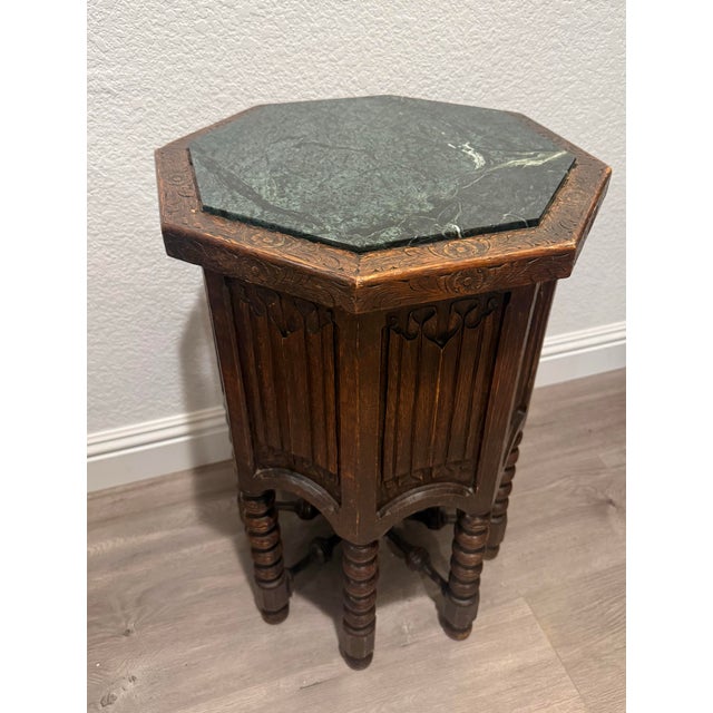 A beautiful pair of early/mid twentieth century octagonal tables or plant stands, featuring inset green marble tops and...