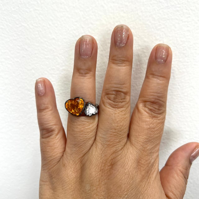 Gorgeous toi et moi ring with a 7.17 ct. GIA orange sapphire heart and 1.28 ct. GIA D SI1 white diamond heart. Handmade in...