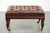 This large brown English-style cowhide Chesterfield ottoman has beautiful legs and stands on casters, making it easy to...