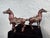 This striking vintage pair of decorative horse sculptures is crafted in cast metal with a rich bronze-toned patina and...