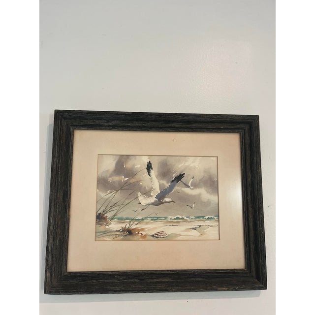 An atmospheric original watercolor by noted American artist J. Everett Draper (1915–2006) depicting seabirds soaring above...
