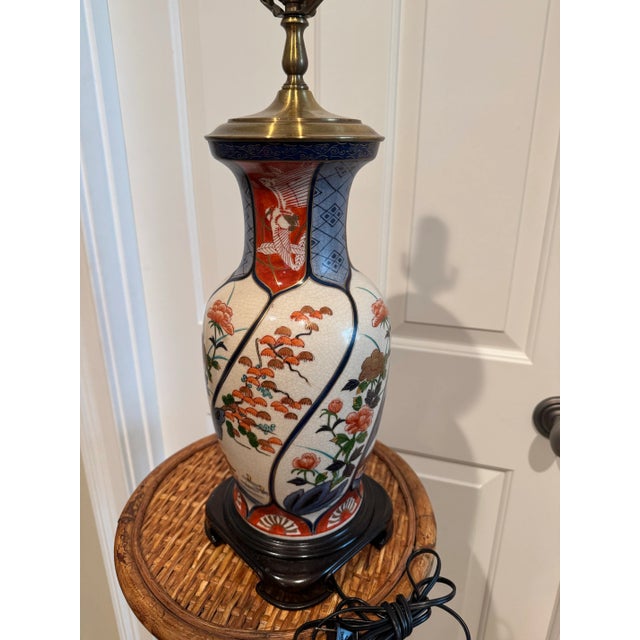 Beautiful vintage porcelain and brass table lamp by Wildwood. The Imari style design is handpainted with red, blue and...