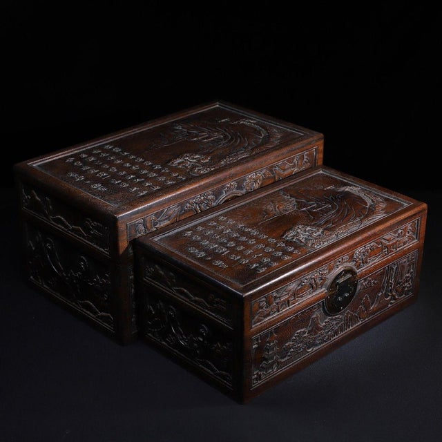 A beautifully crafted set of two Chinese hardwood nesting boxes, likely made of Huali (rosewood). Each box features deep...