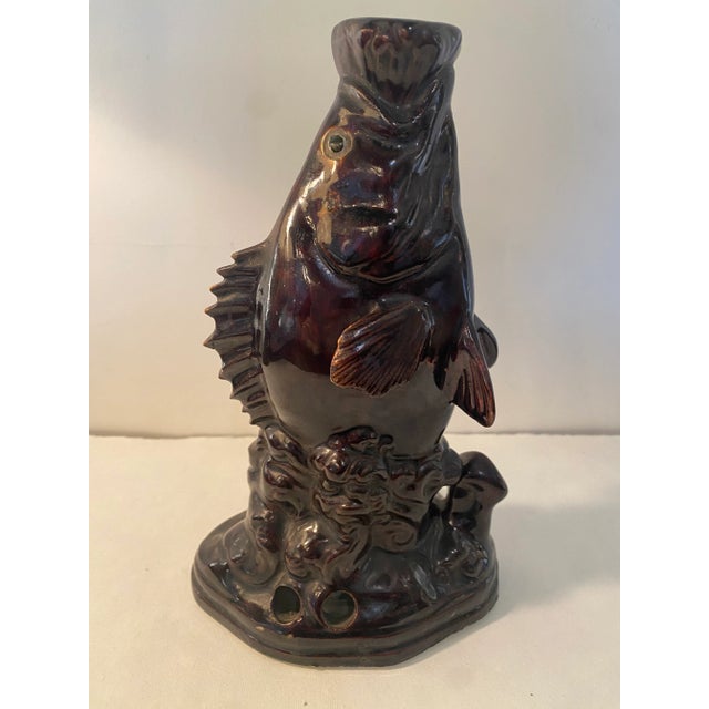 Very unusual vase or jug like ( except there are two glazed holes cut into the side near base) earthenware fish. Most...