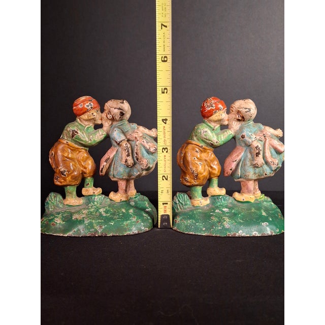Offered is an original 1920s matched pair of cast iron "Kissing Dutch Kids" bookends manufactured by the premier Hubley...