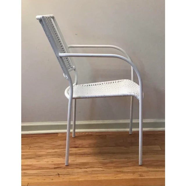 Armchair with lacquered metal frame, with thick white twist rope. The lightweight has clean, minimalistic design with its...